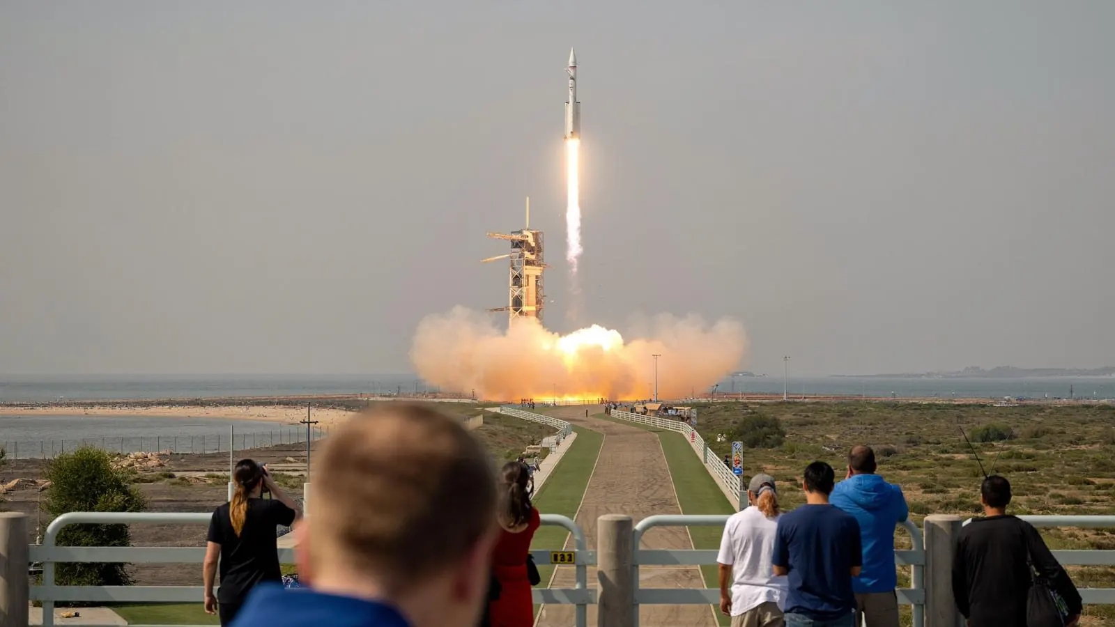 A launch vehicle lifts off on a column of flame and smoke.